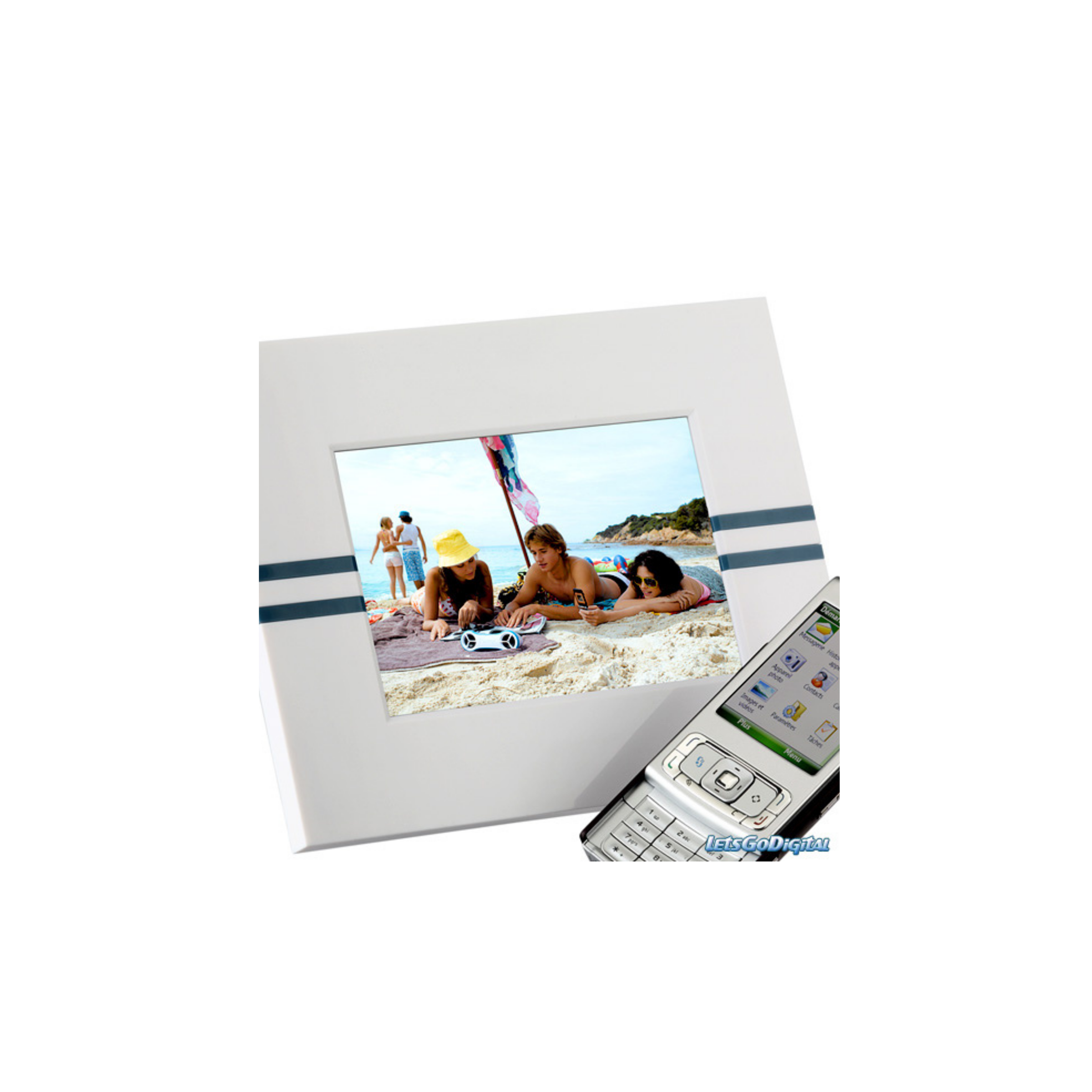 White digital photo frame showing a beach scene with several people, next to a silver slider phone on its menu screen
