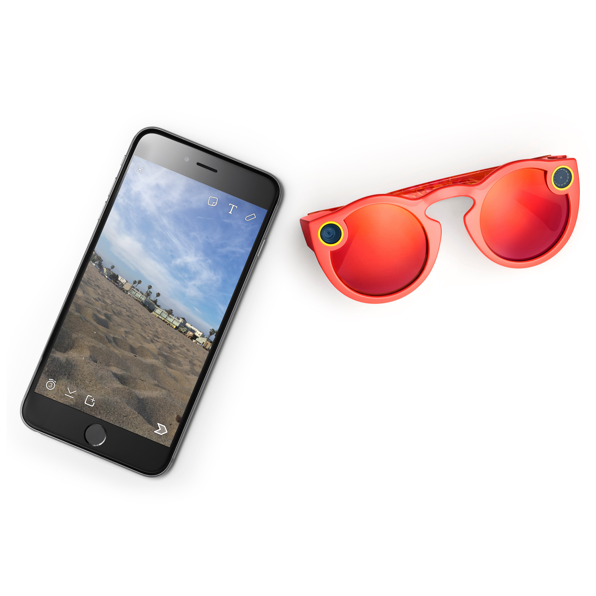 Coral Spectacles camera sunglasses with mirrored lenses and yellow camera rings, beside an iPhone showing a beach capture